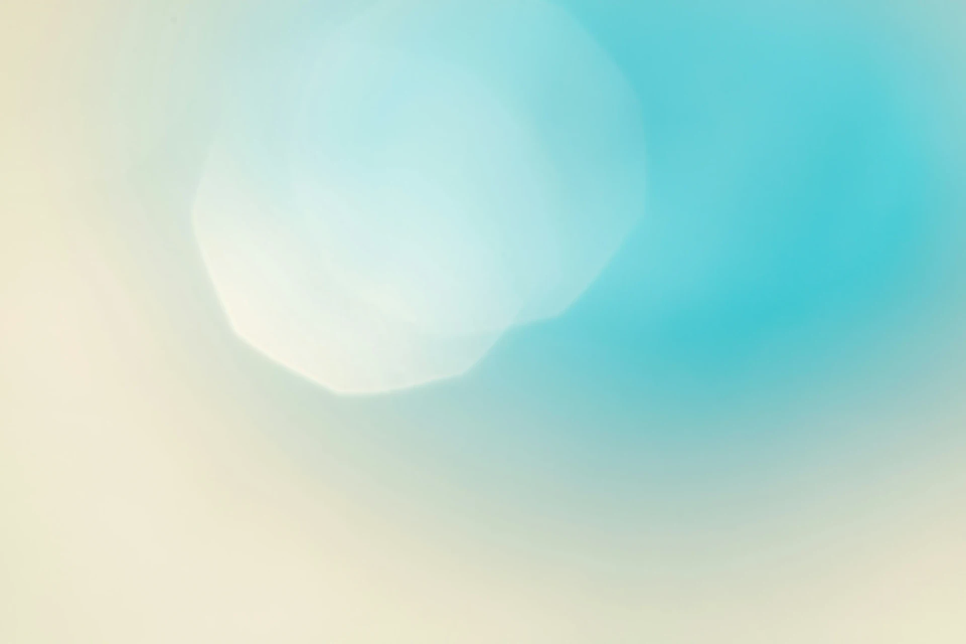 Soft blue and beige abstract background with bokeh lights.